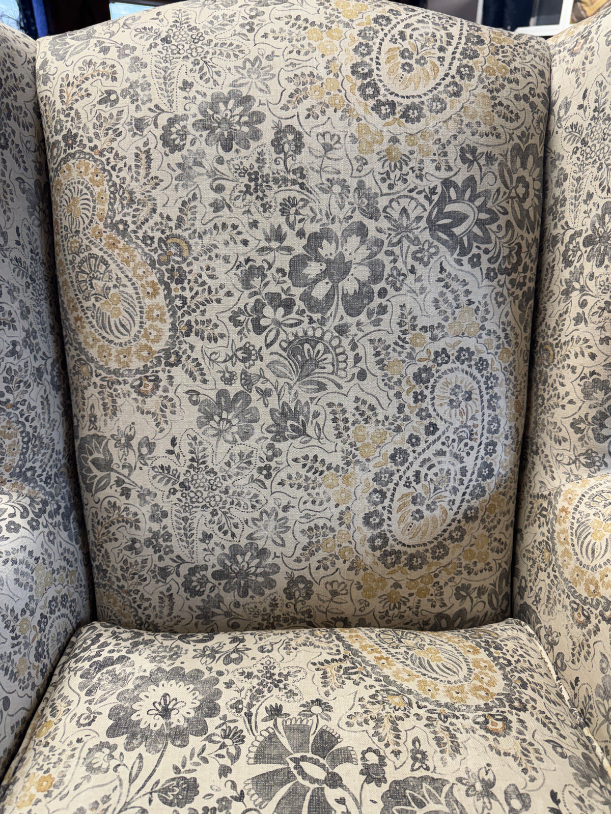 Heather wingback accent chair in grey / ochre Paisley print fabric