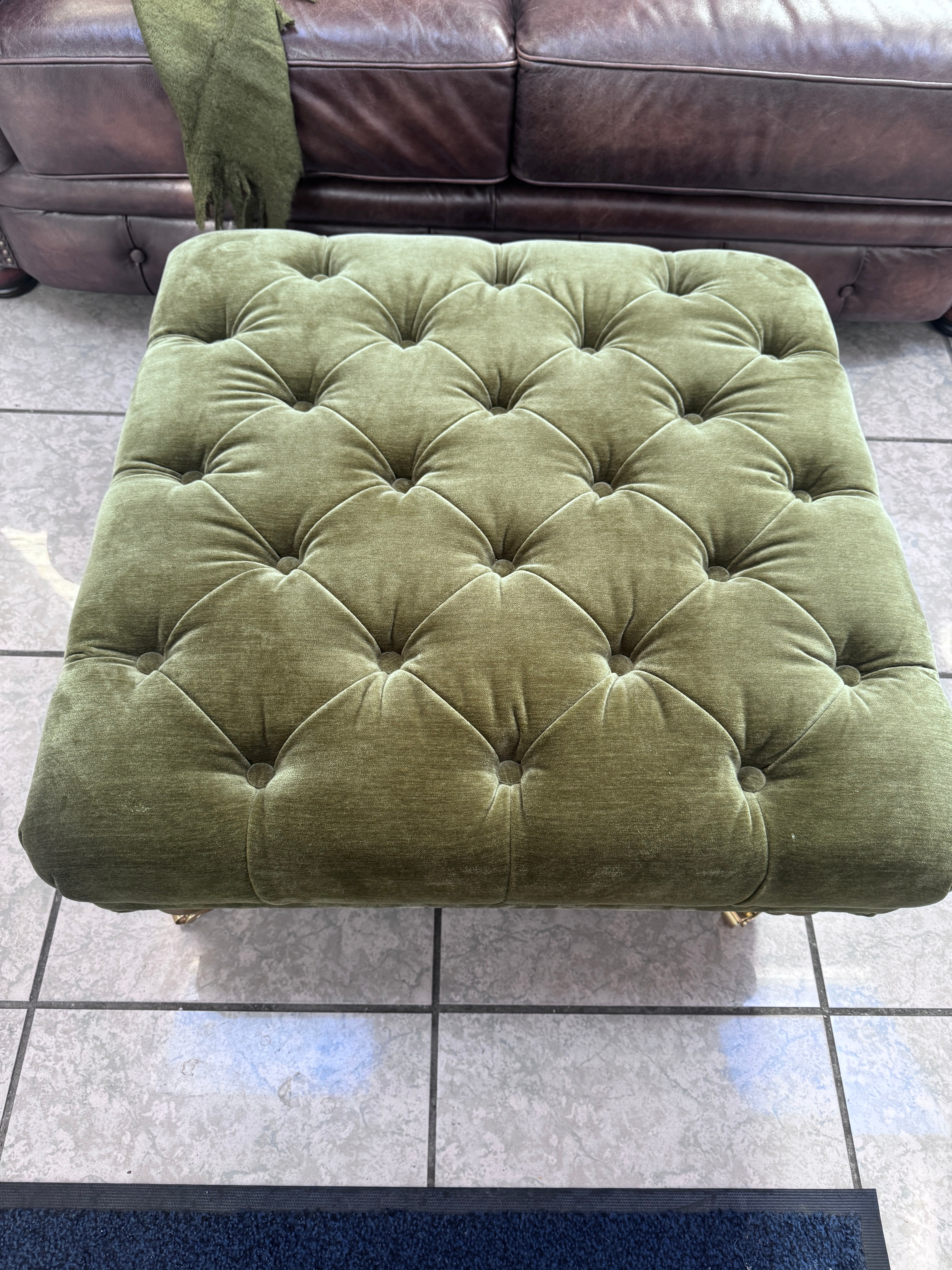 Shackleton square button top footstool with castors in Pine green velvet