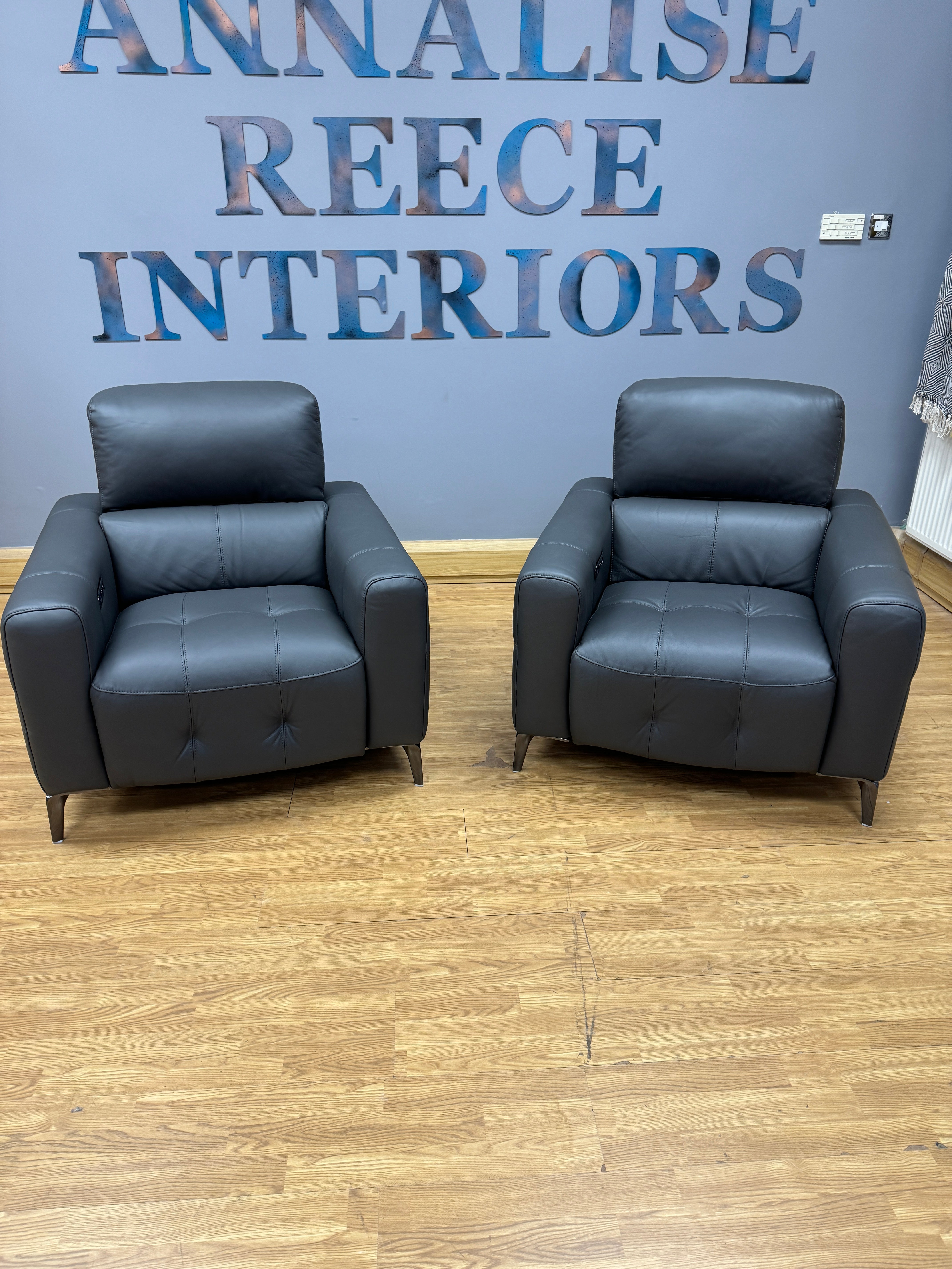 New York pair of matching reclining armchairs in dark grey leather