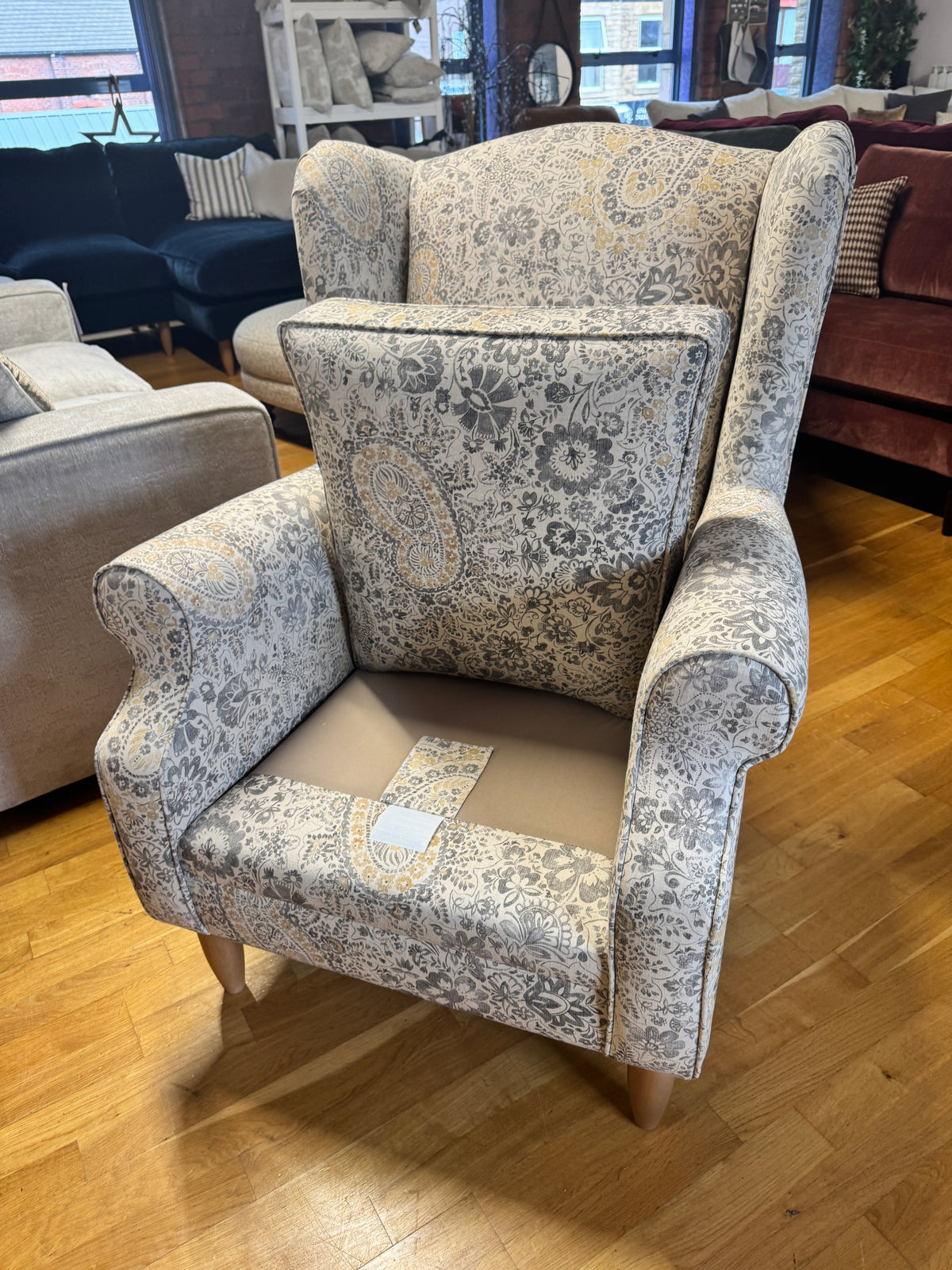 Heather wingback accent chair in grey / ochre Paisley print fabric