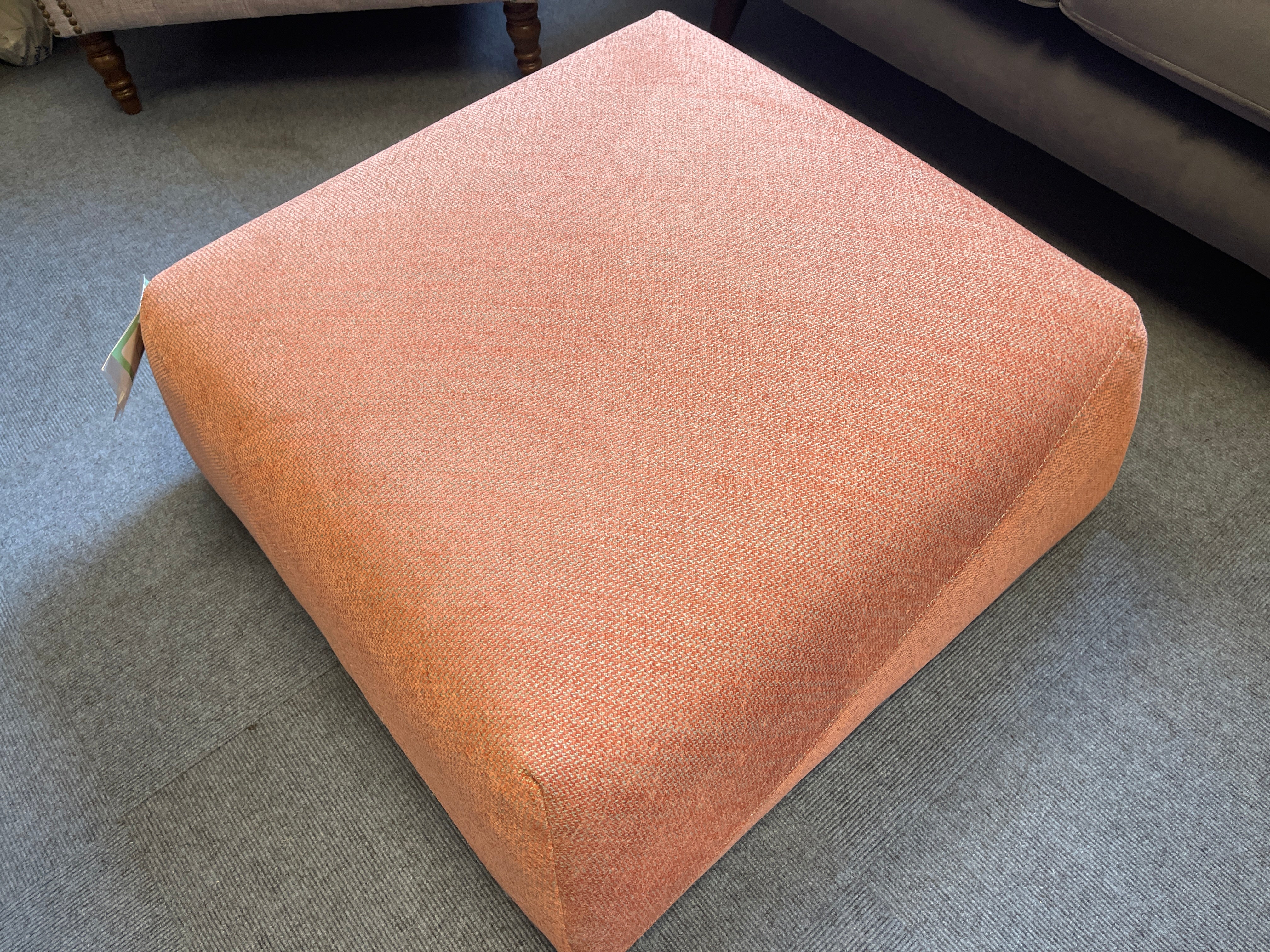 Sample square shape footstool in peach orange weave